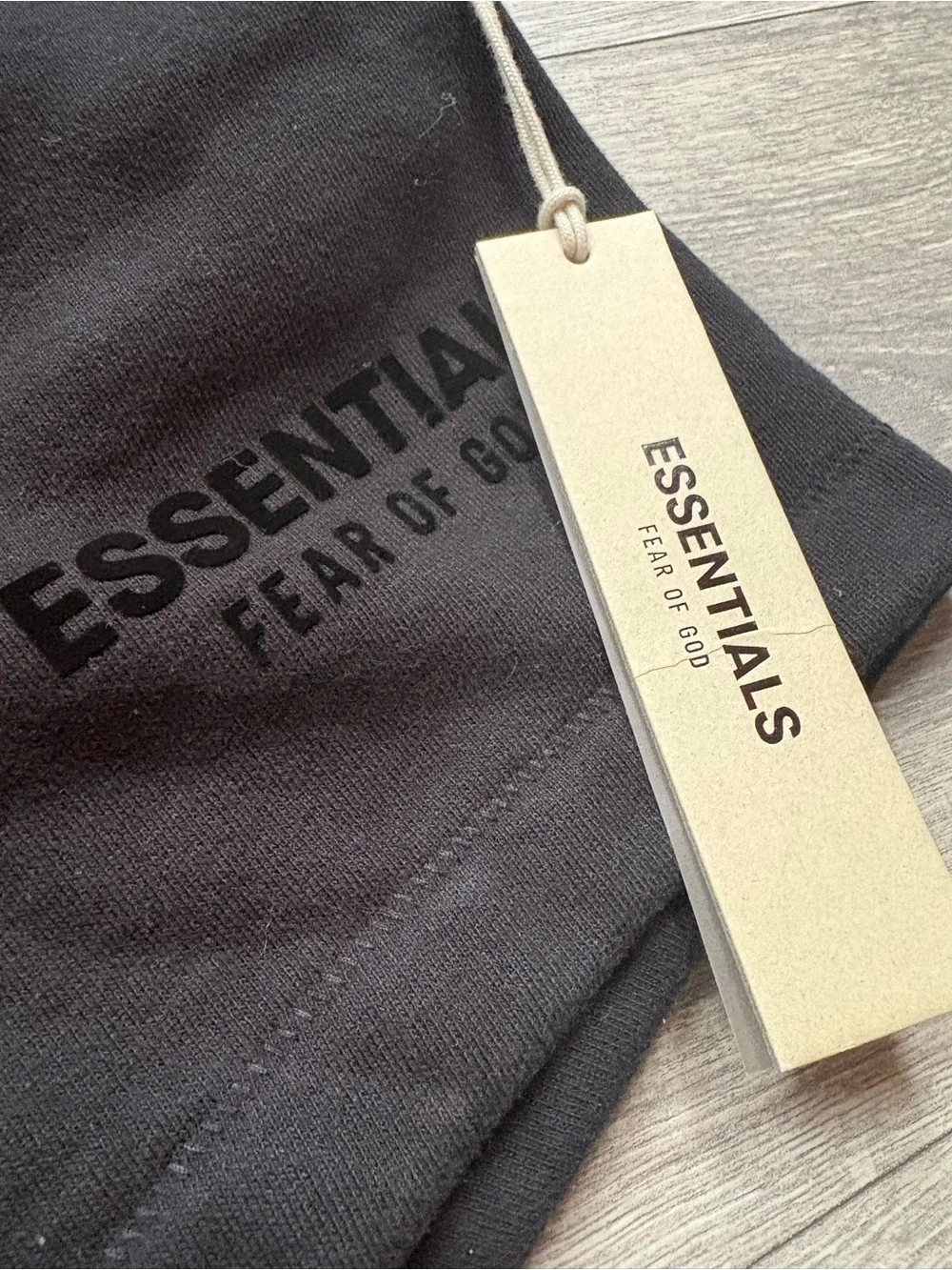 Fear of God ESSENTIALS Black Tee with Cream Hang Tag